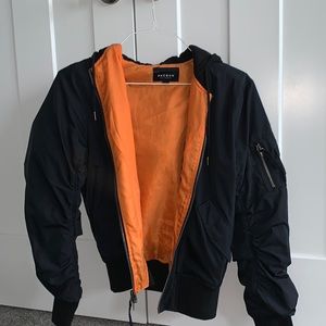 Bomber jacket with hood in black and orange